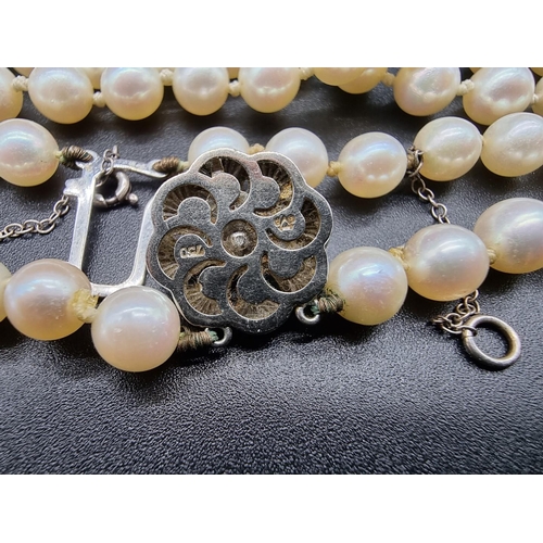 801 - A pearl two strand necklace, having clasp stamped 18k, by GVS, 44cm.