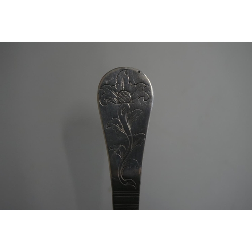 584 - An unmarked white metal spoon, having chased decoration to terminal and bowl back, 17cm.... 