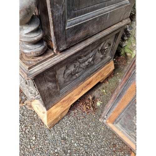 1000 - An antique continental oak two door cupboard, having a pair of glazed doors, 230cm high x 111.5... 