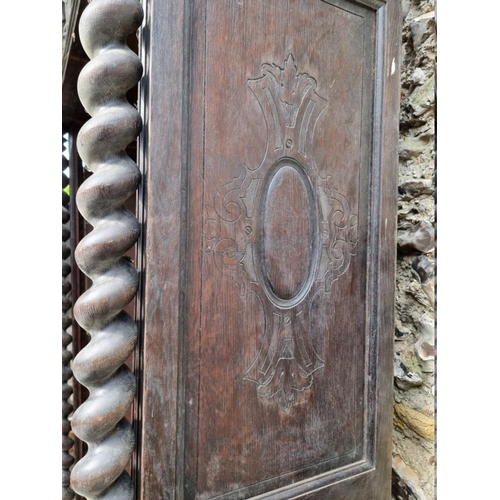 1000 - An antique continental oak two door cupboard, having a pair of glazed doors, 230cm high x 111.5... 