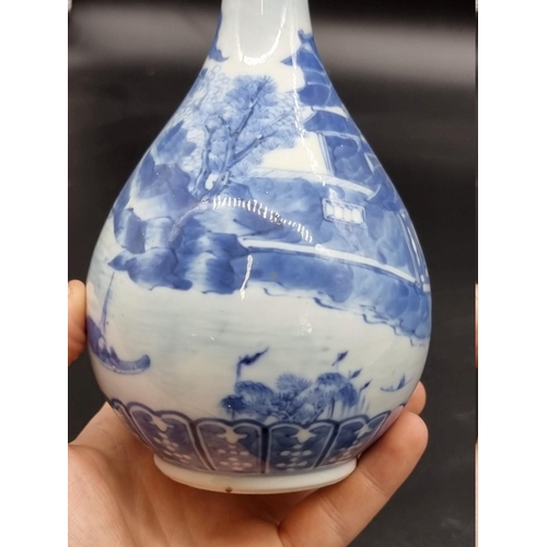 1634 - A Chinese blue and white bottle vase, Kangxi four character mark to base, 20cm high, on hardwood sta... 