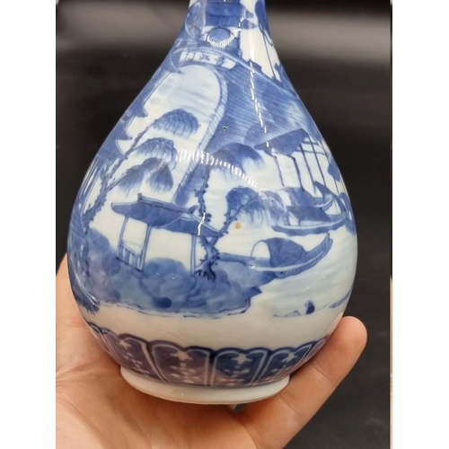 1634 - A Chinese blue and white bottle vase, Kangxi four character mark to base, 20cm high, on hardwood sta... 