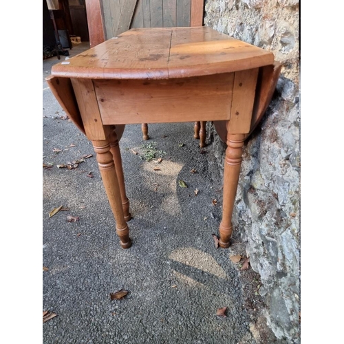 1001 - An antique pine dropleaf table, 136cm wide x 70cm high.