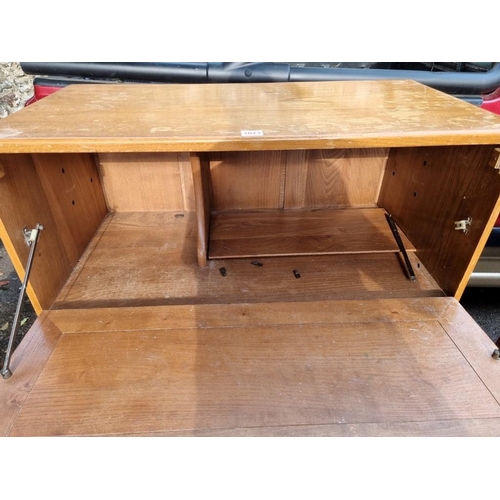 1023 - An Ercol bureau, 82.5cm wide x 43cm deep x 110cm high.