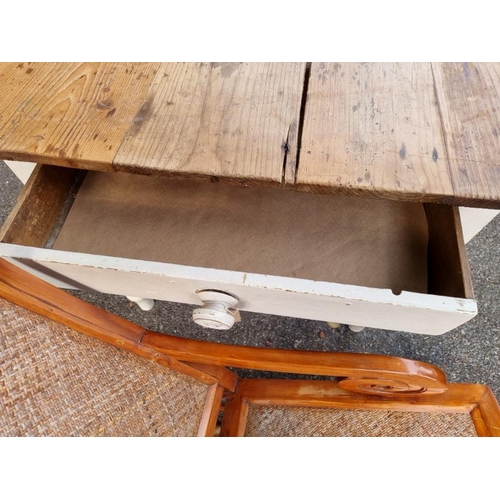 1028 - An antique pine kitchen table, having one drawer and white painted legs, 120cm wide x 83cm deep x 74... 