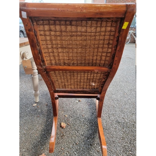 1029 - An old rattan rocking chair; together with an old map and two further prints. (4)