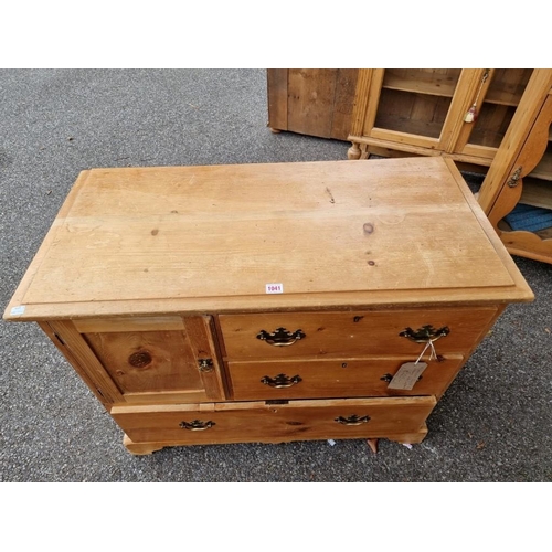 1041 - A Victorian pine chest of drawers, with one cupboard door, 96.5cm wide x 46.5cm deep x 76.5cm high.... 