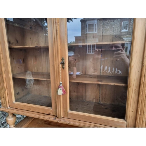 1044 - A Victorian carved pine bookcase cabinet, 110cm wide x 49cm deep x 215cm high.