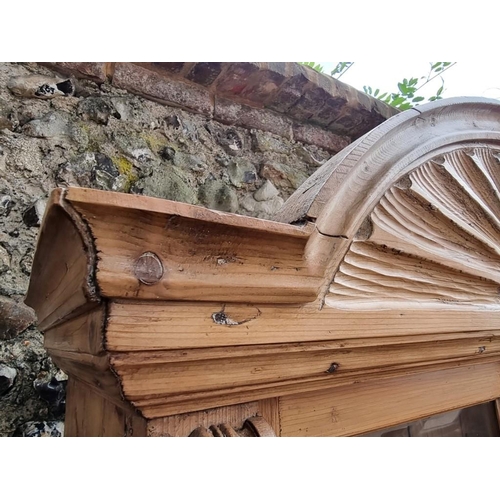 1044 - A Victorian carved pine bookcase cabinet, 110cm wide x 49cm deep x 215cm high.