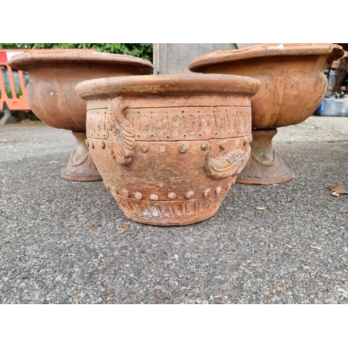 1045 - A pair of terracotta urns, (cracked); together with another terracotta pot.