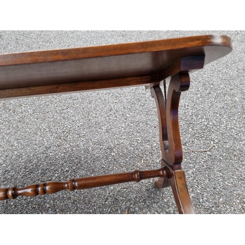 1047 - A reproduction mahogany and crossbanded low occasional table, with lyre ends, 90.5cm wide.... 