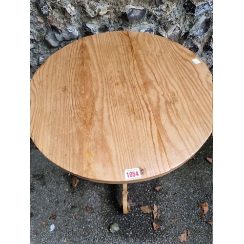 1054 - A small pine tripod table, 54cm wide x 78.5cm high.