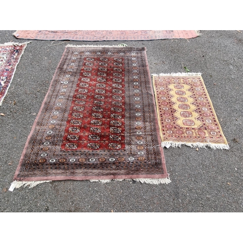 1059 - A Bokhara rug; together with a smaller example. 