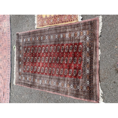 1059 - A Bokhara rug; together with a smaller example. 