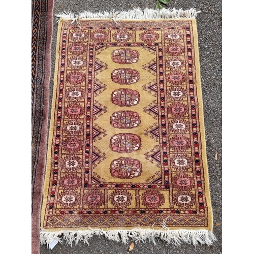 1059 - A Bokhara rug; together with a smaller example. 