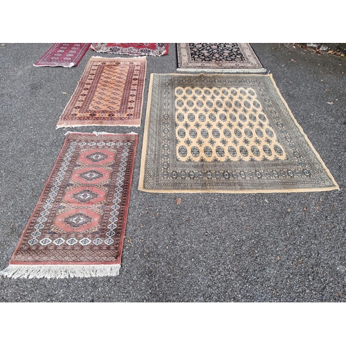 1061 - A square Persian Bokhara; together with two other Bokhara rugs.