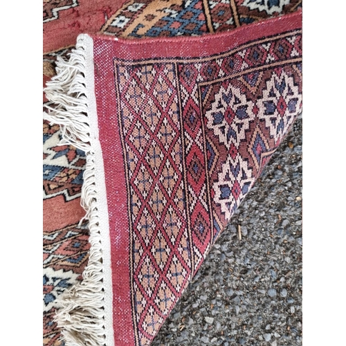 1061 - A square Persian Bokhara; together with two other Bokhara rugs.