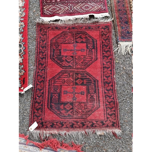 1062 - A Bokhara runner, having repeated central field; together with a small Bokhara rug and one othe... 