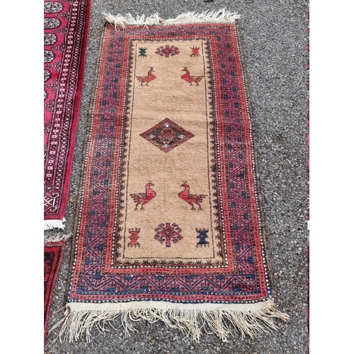 1062 - A Bokhara runner, having repeated central field; together with a small Bokhara rug and one othe... 