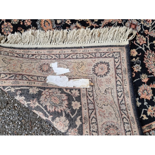 1064 - A Persian rug, having allover floral decoration, on black ground, 196cm x 140cm. ... 