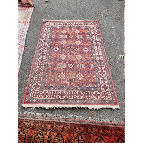 1067 - A Persian rug, having allover central floral field, with floral borders, 204cm x 133cm.... 