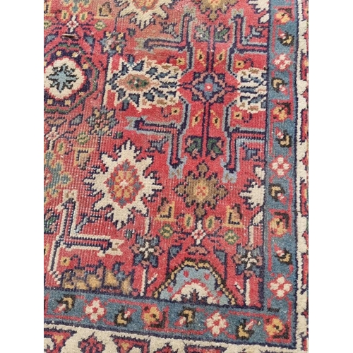 1067 - A Persian rug, having allover central floral field, with floral borders, 204cm x 133cm.... 