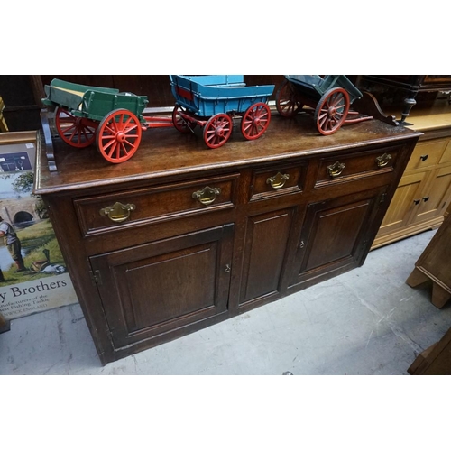 1079 - A George III oak dresser and rack, 155cm wide. 