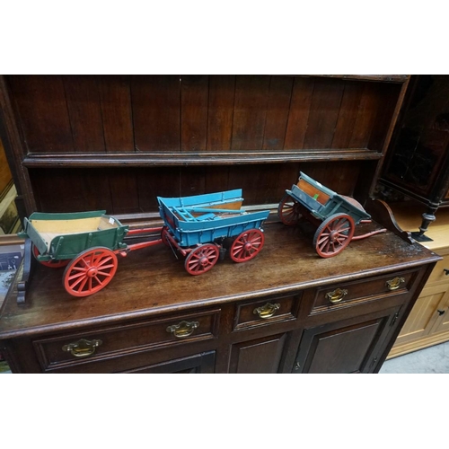 1080 - Three scratch built painted wood wagons, largest 62cm long. (3)