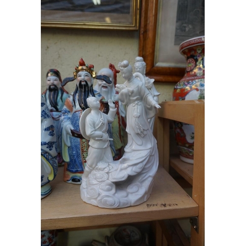 1102 - Nine Chinese famille rose figures, largest 35cm high; together with two further blanc de chine figur... 