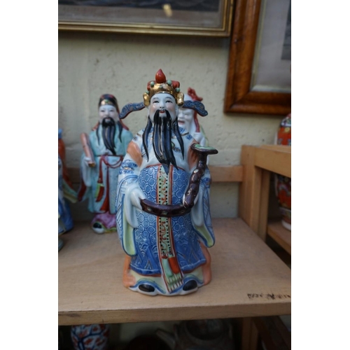 1102 - Nine Chinese famille rose figures, largest 35cm high; together with two further blanc de chine figur... 