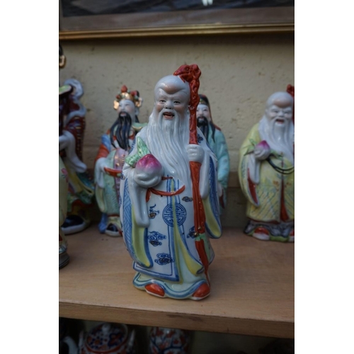 1102 - Nine Chinese famille rose figures, largest 35cm high; together with two further blanc de chine figur... 