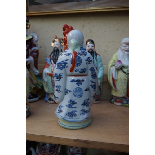 1102 - Nine Chinese famille rose figures, largest 35cm high; together with two further blanc de chine figur... 