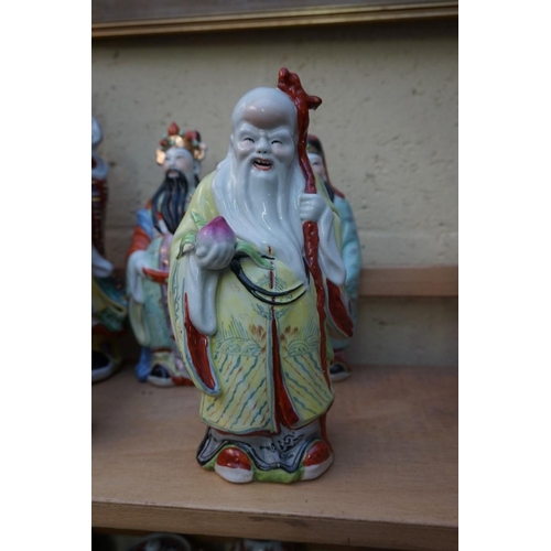 1102 - Nine Chinese famille rose figures, largest 35cm high; together with two further blanc de chine figur... 