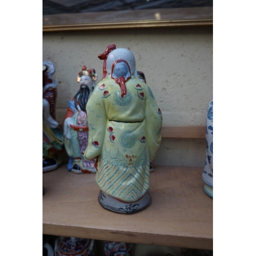 1102 - Nine Chinese famille rose figures, largest 35cm high; together with two further blanc de chine figur... 