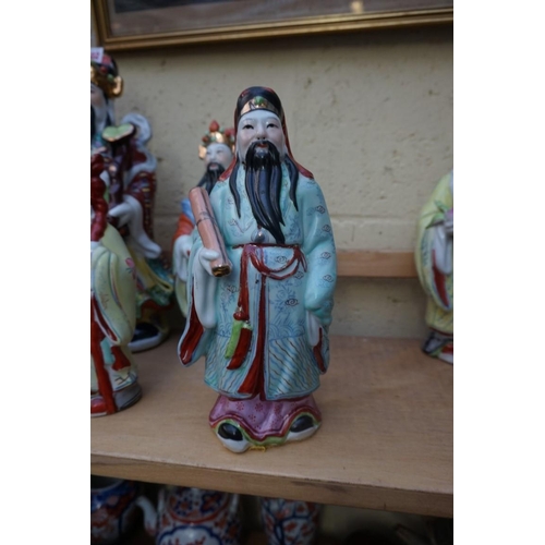 1102 - Nine Chinese famille rose figures, largest 35cm high; together with two further blanc de chine figur... 