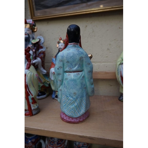 1102 - Nine Chinese famille rose figures, largest 35cm high; together with two further blanc de chine figur... 