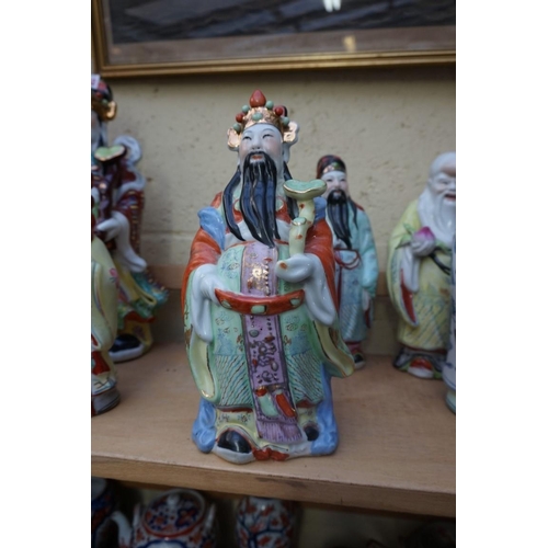 1102 - Nine Chinese famille rose figures, largest 35cm high; together with two further blanc de chine figur... 