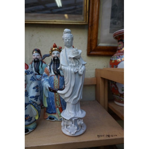 1102 - Nine Chinese famille rose figures, largest 35cm high; together with two further blanc de chine figur... 