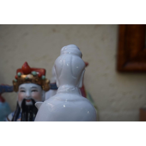 1102 - Nine Chinese famille rose figures, largest 35cm high; together with two further blanc de chine figur... 