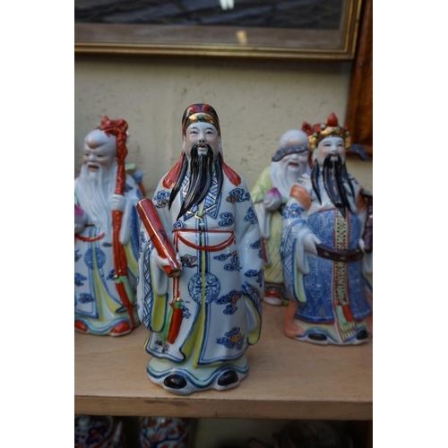 1102 - Nine Chinese famille rose figures, largest 35cm high; together with two further blanc de chine figur... 