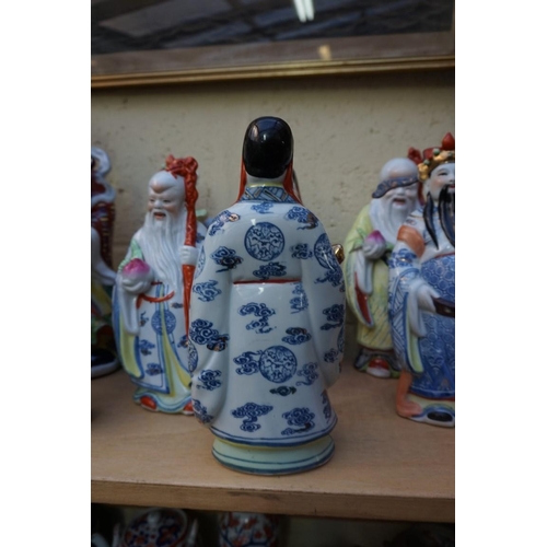 1102 - Nine Chinese famille rose figures, largest 35cm high; together with two further blanc de chine figur... 