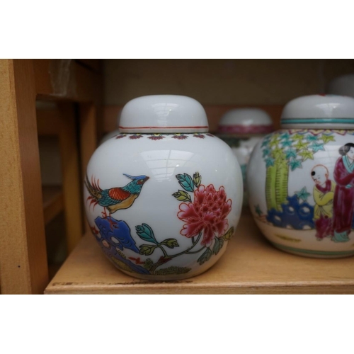 1111 - A collection of Chinese famille rose vases and jars, largest 17cm high. (12)