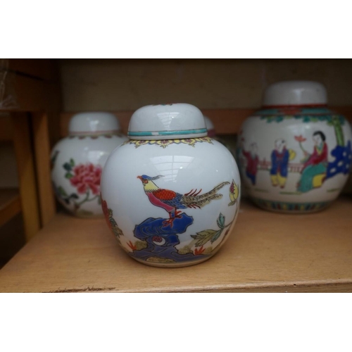 1111 - A collection of Chinese famille rose vases and jars, largest 17cm high. (12)