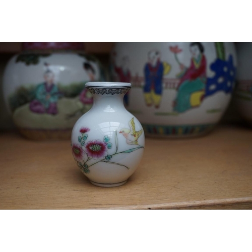 1111 - A collection of Chinese famille rose vases and jars, largest 17cm high. (12)