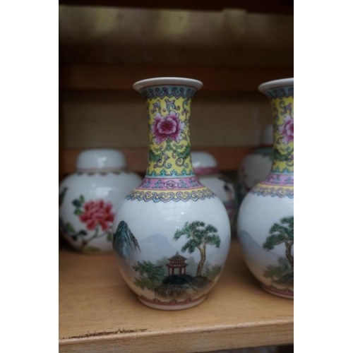 1111 - A collection of Chinese famille rose vases and jars, largest 17cm high. (12)