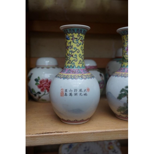 1111 - A collection of Chinese famille rose vases and jars, largest 17cm high. (12)