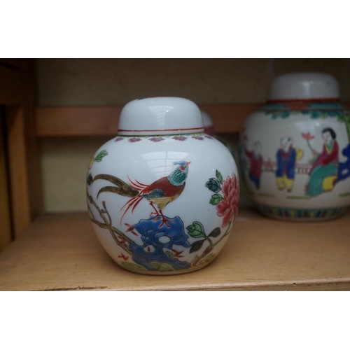 1111 - A collection of Chinese famille rose vases and jars, largest 17cm high. (12)