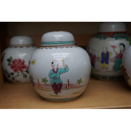 1111 - A collection of Chinese famille rose vases and jars, largest 17cm high. (12)