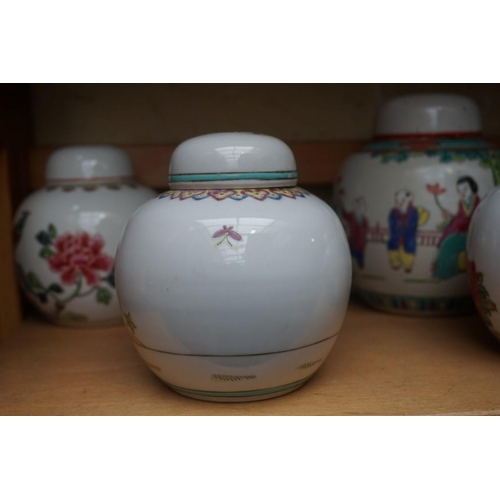 1111 - A collection of Chinese famille rose vases and jars, largest 17cm high. (12)