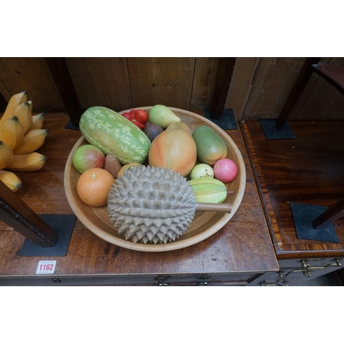 1161 - A collection of novelty painted and carved life-size fruit, together with a turned wood bowl, 38cm d... 